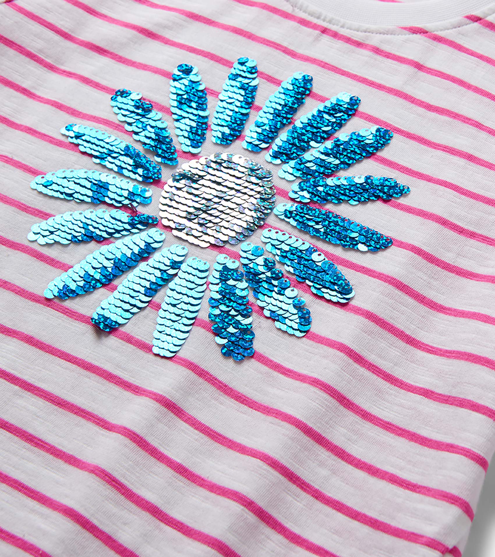 Girls white and pink striped T-shirt with blue sequin flower graphic, close-up front view