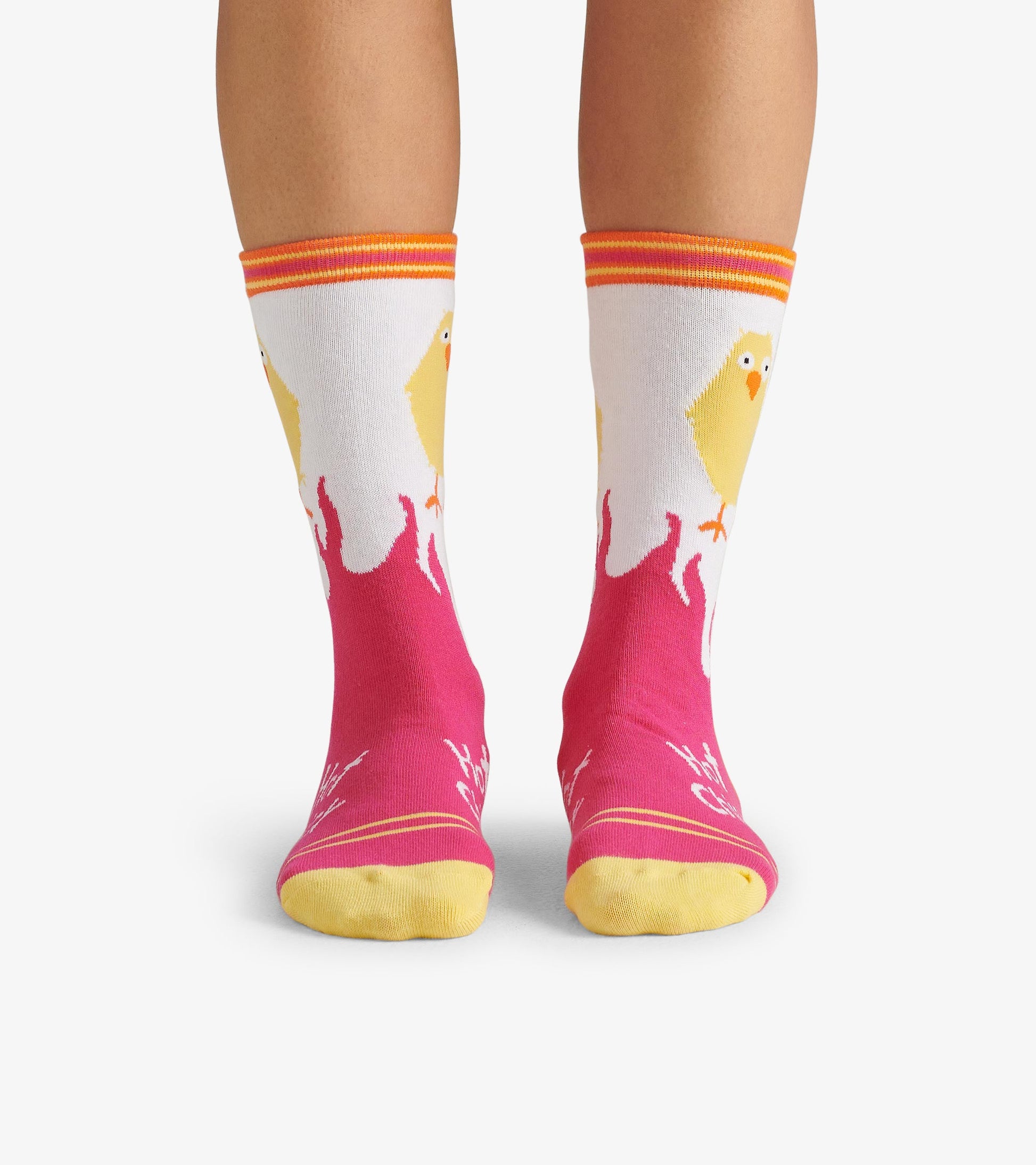 Colorful crew socks featuring a yellow chick design on a pink background with orange and yellow accents.