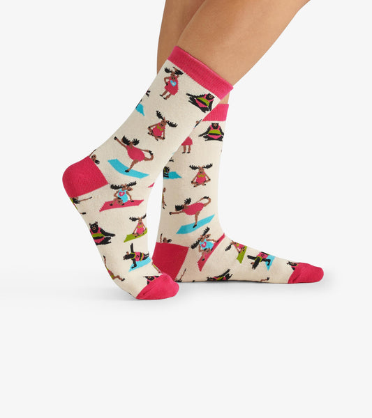 Cream crew socks featuring colorful yoga-themed patterns and pink accents. One size fits all.