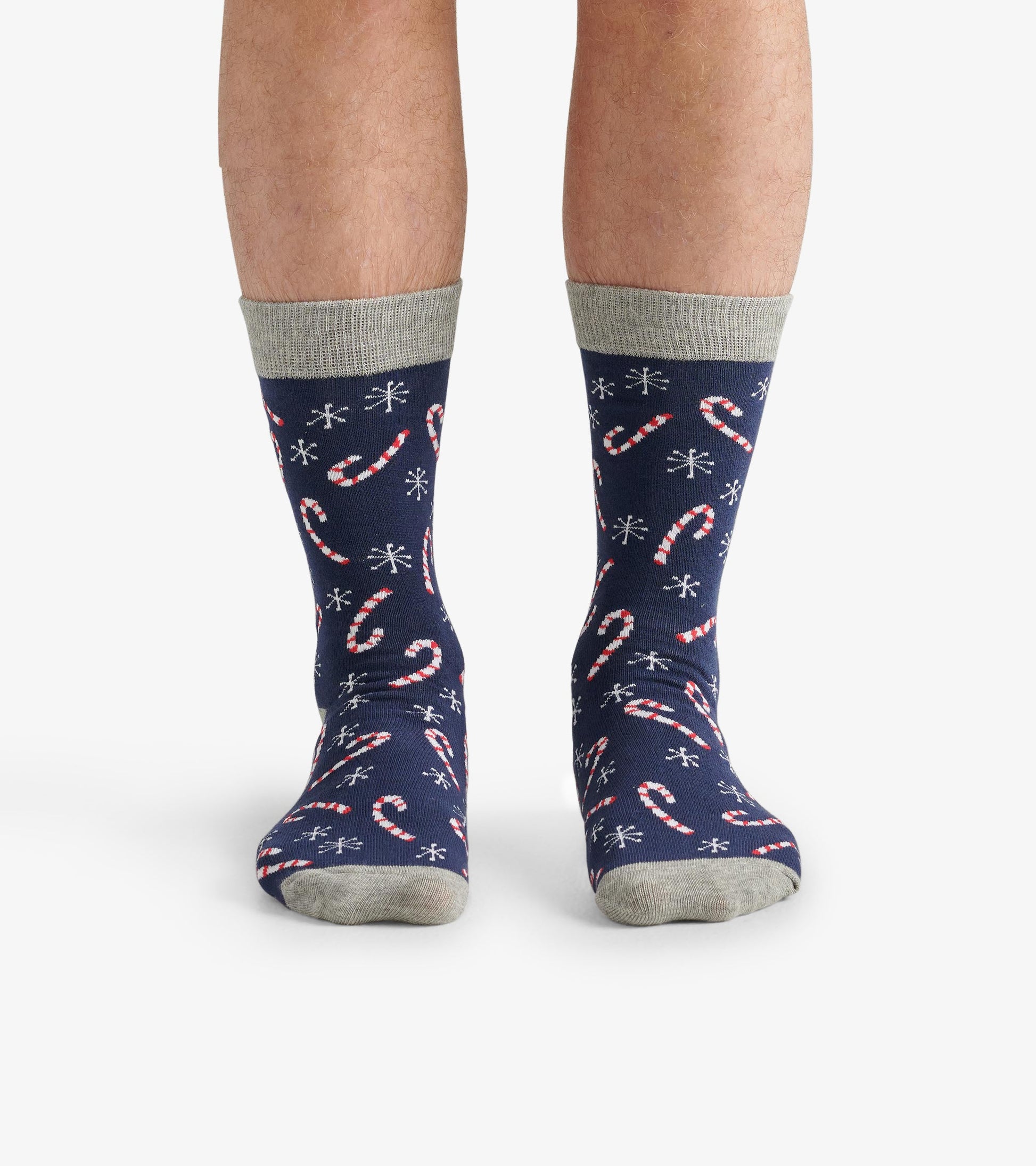 Navy crew socks featuring a candy cane pattern and snowflakes, with a light gray cuff and toe.