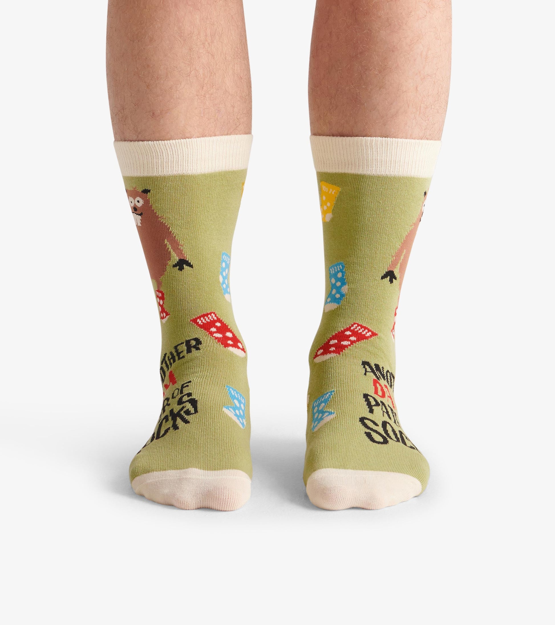 Men's crew socks in green with playful patterns of socks and a bear, featuring a light-colored cuff and toe.
