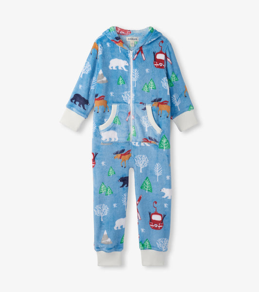 Blue fleece jumpsuit with a hood, featuring colorful winter animal and tree patterns, zip front, and pockets.