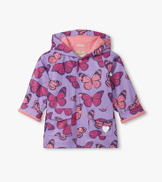 Purple hooded girls raincoat with pink butterfly print, front view, button-up with pockets and pink lining