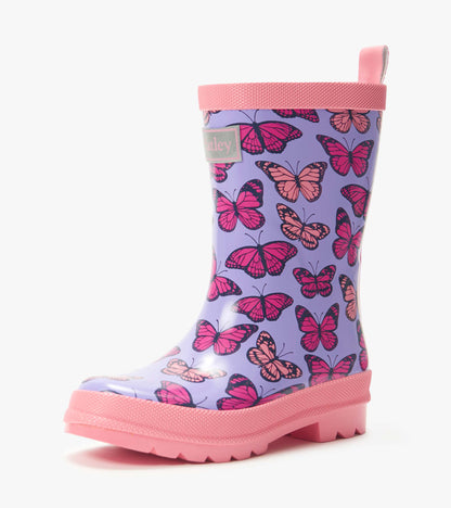 Purple kids rain boot with pink butterfly print and pink sole, side view