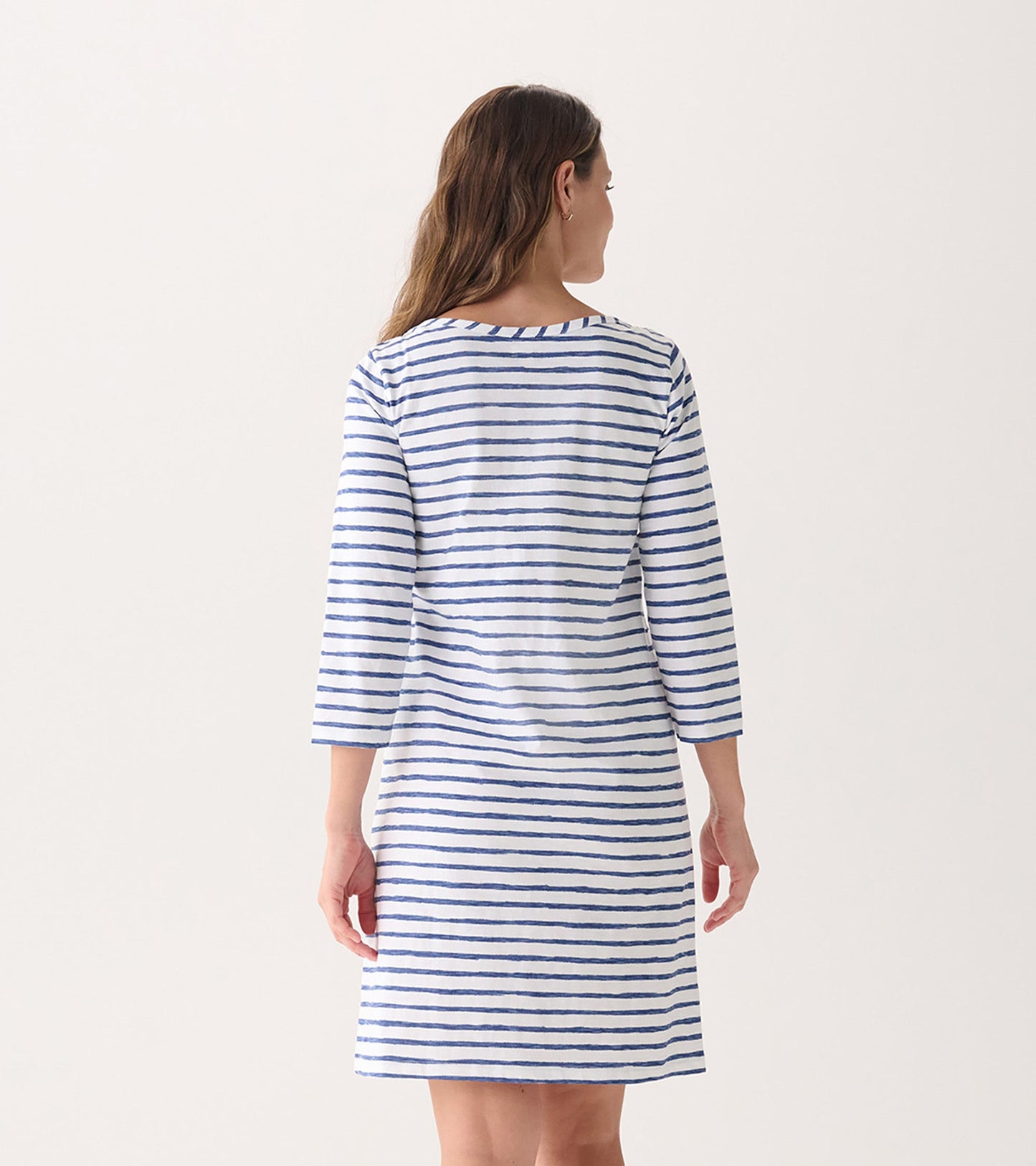 Back view of a women's summer dress featuring watercolor stripes in blue and white, with 3/4 sleeves and a relaxed fit.