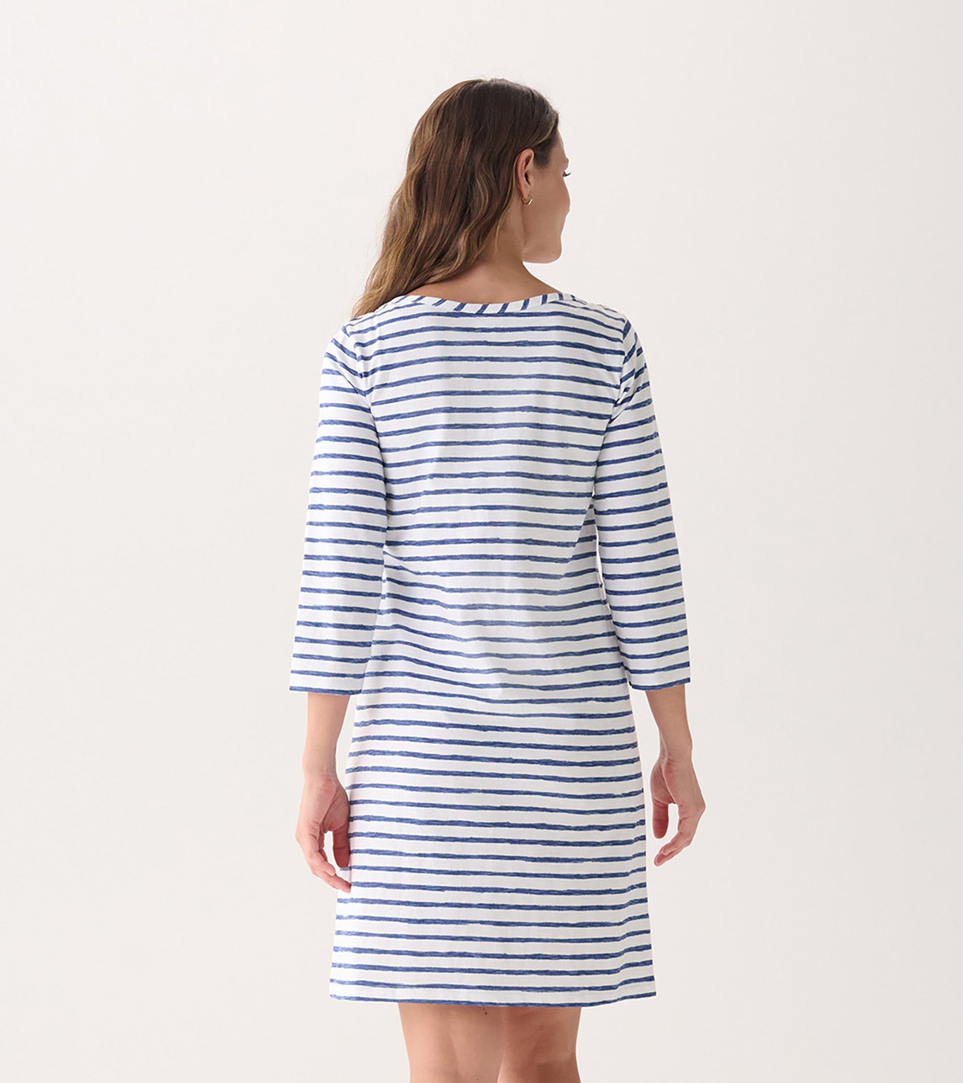 Back view of a women's summer dress featuring watercolor stripes in blue and white, with 3/4 sleeves and a relaxed fit.