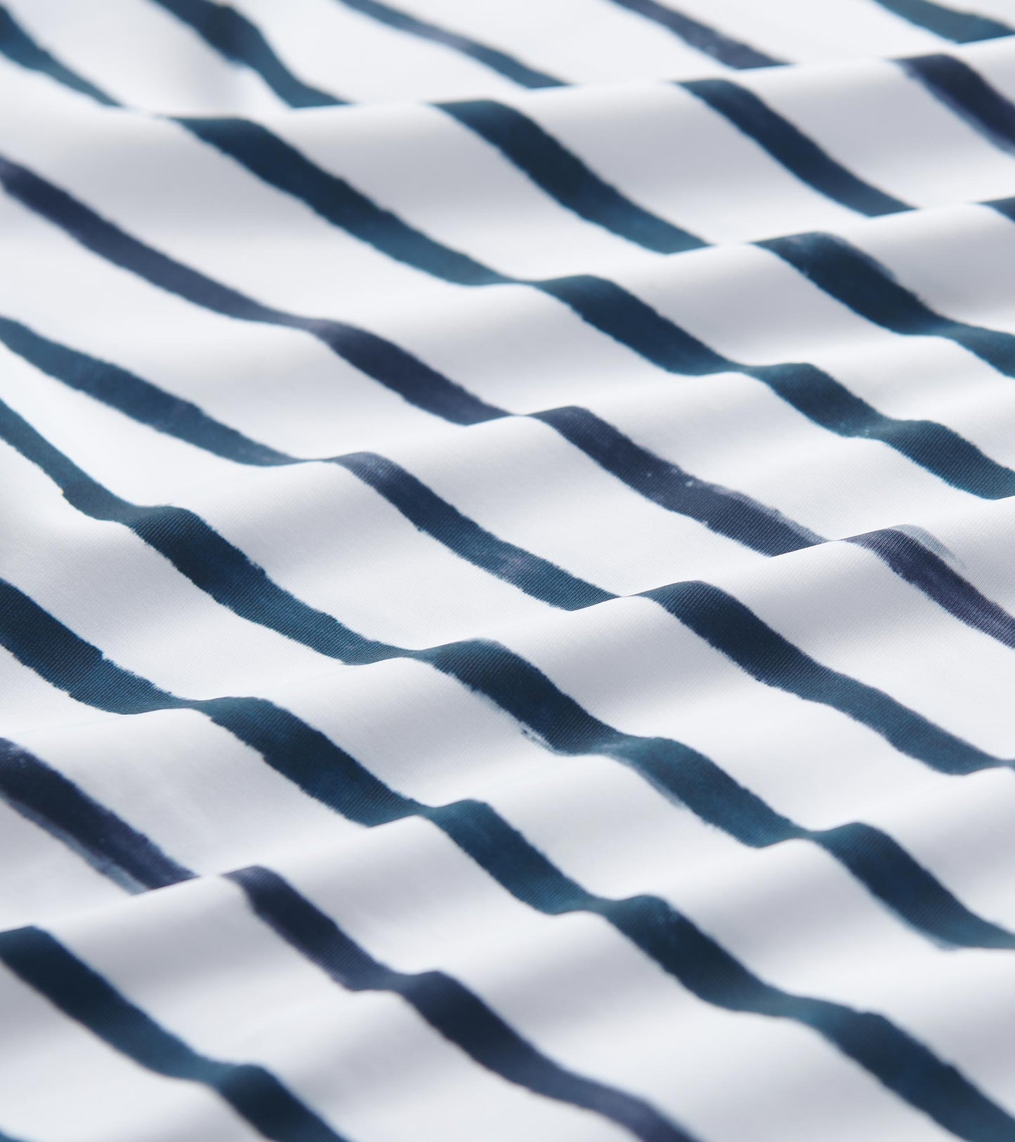 White fabric featuring watercolor stripes in navy blue, suitable for a 3/4 sleeve summer dress.