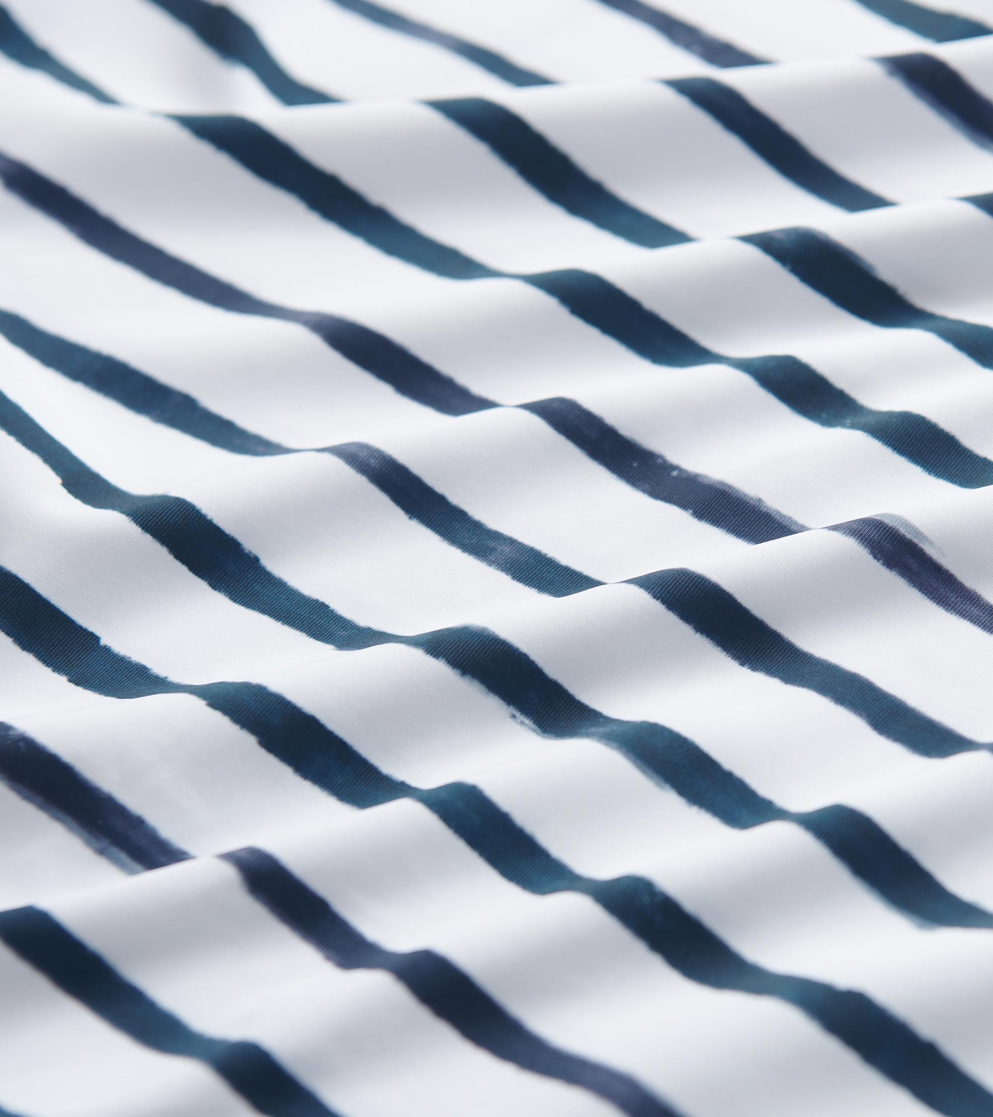 White fabric featuring watercolor stripes in navy blue, suitable for a 3/4 sleeve summer dress.