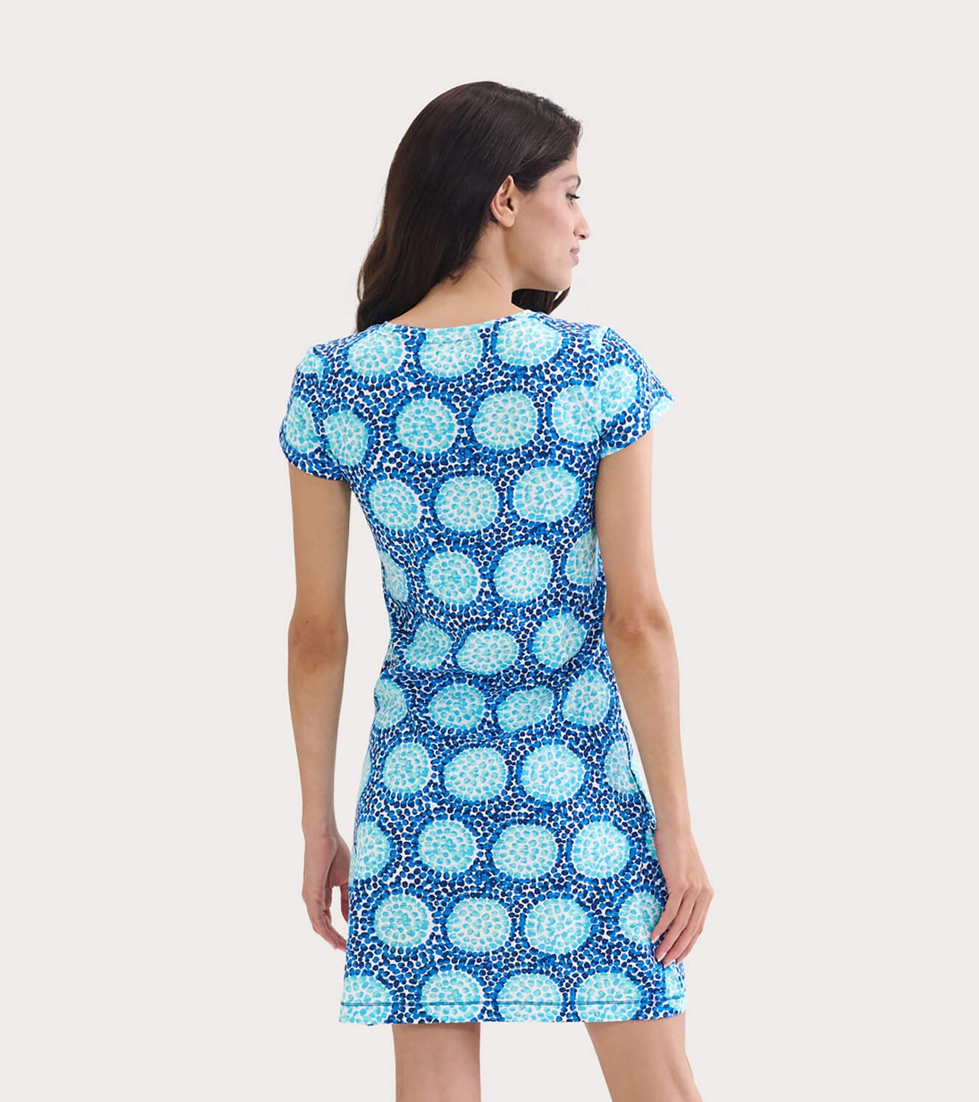 Short-sleeve crew neck t-shirt dress in blue with a circular pattern, shown from the back.