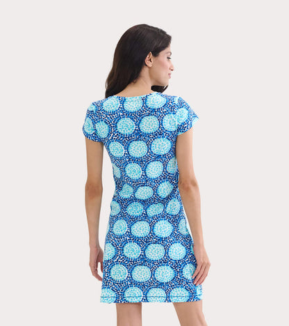 Short-sleeve crew neck t-shirt dress in blue with a circular pattern, shown from the back.