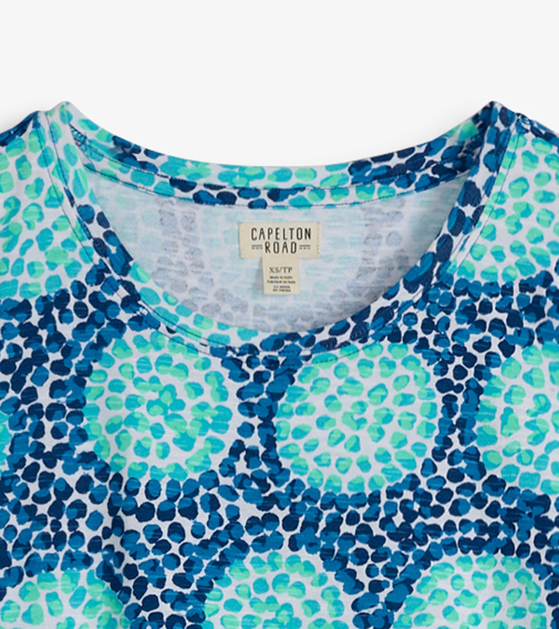 Crew neck t-shirt dress featuring a blue and green abstract pattern on a light background.