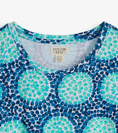 Crew neck t-shirt dress featuring a blue and green abstract pattern on a light background.