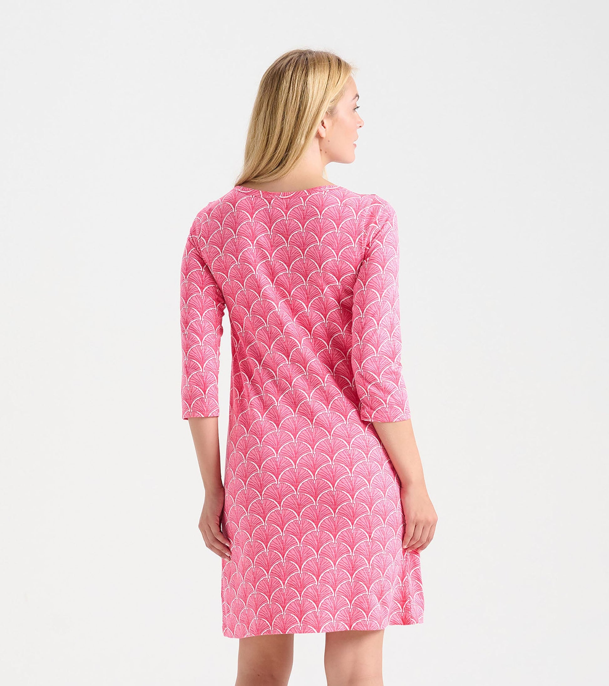Coral pink summer dress with 3/4 sleeves and a fan pattern, shown from the back.