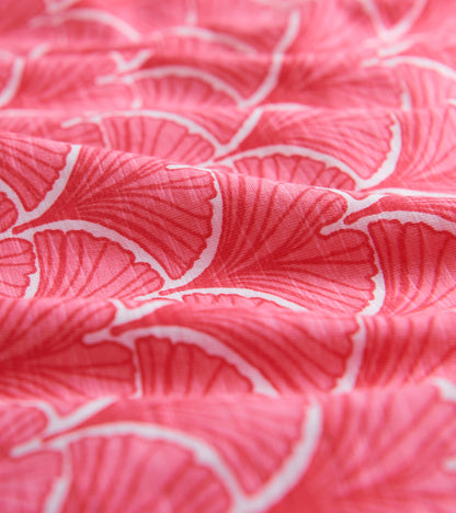 Coral fabric featuring a fan pattern, ideal for summer wear with 3/4 sleeves.