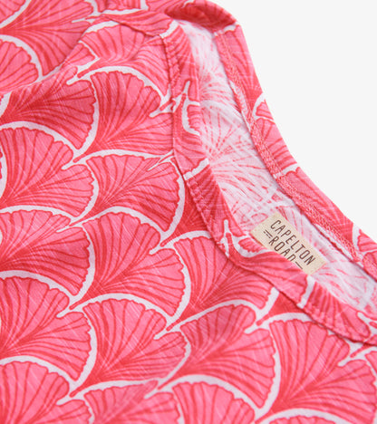 Coral summer dress featuring a fan pattern and 3/4 sleeves, showcasing a soft fabric and round neckline.