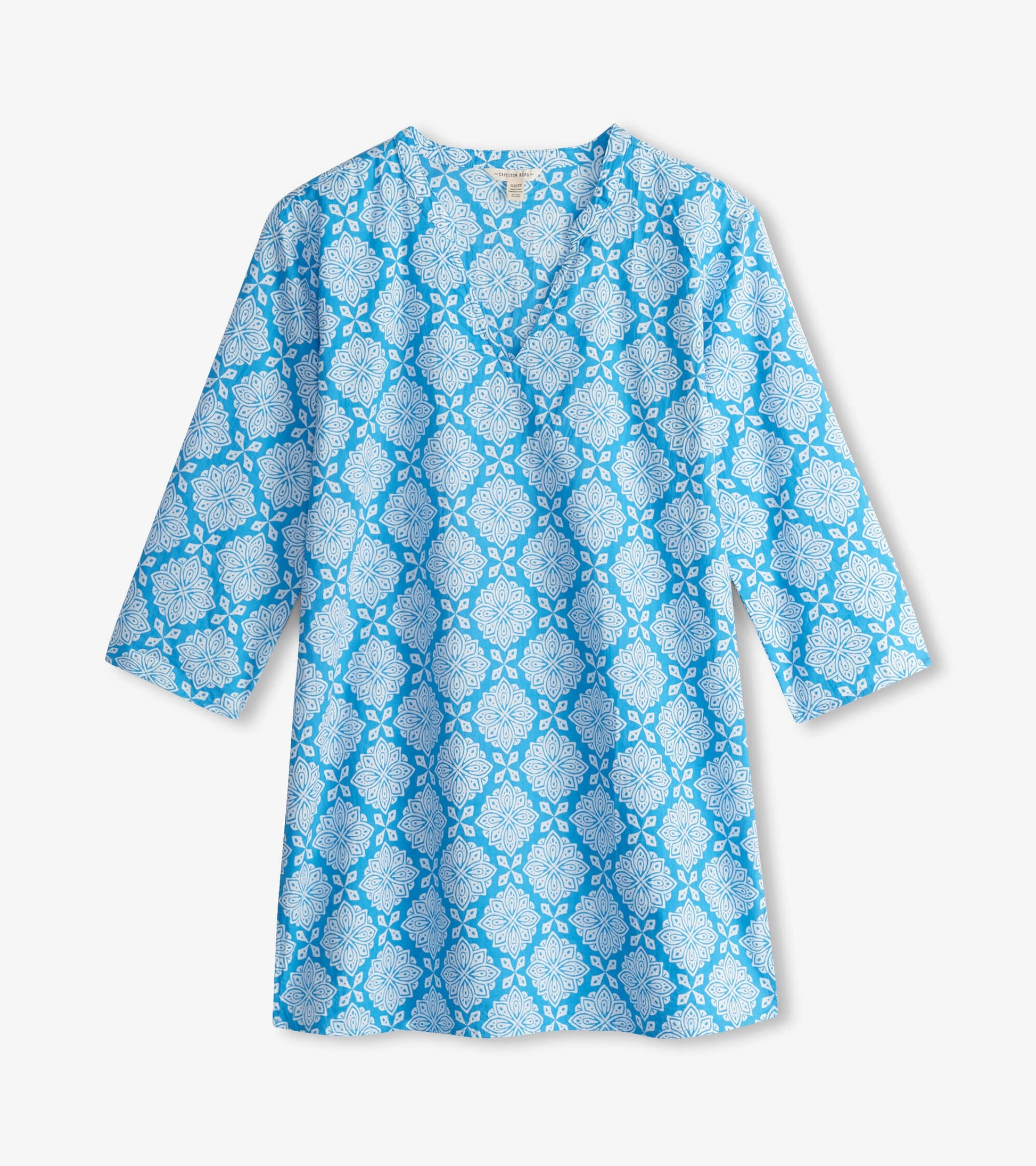 Blue tunic featuring a white floral pattern and three-quarter sleeves, ideal for casual wear.