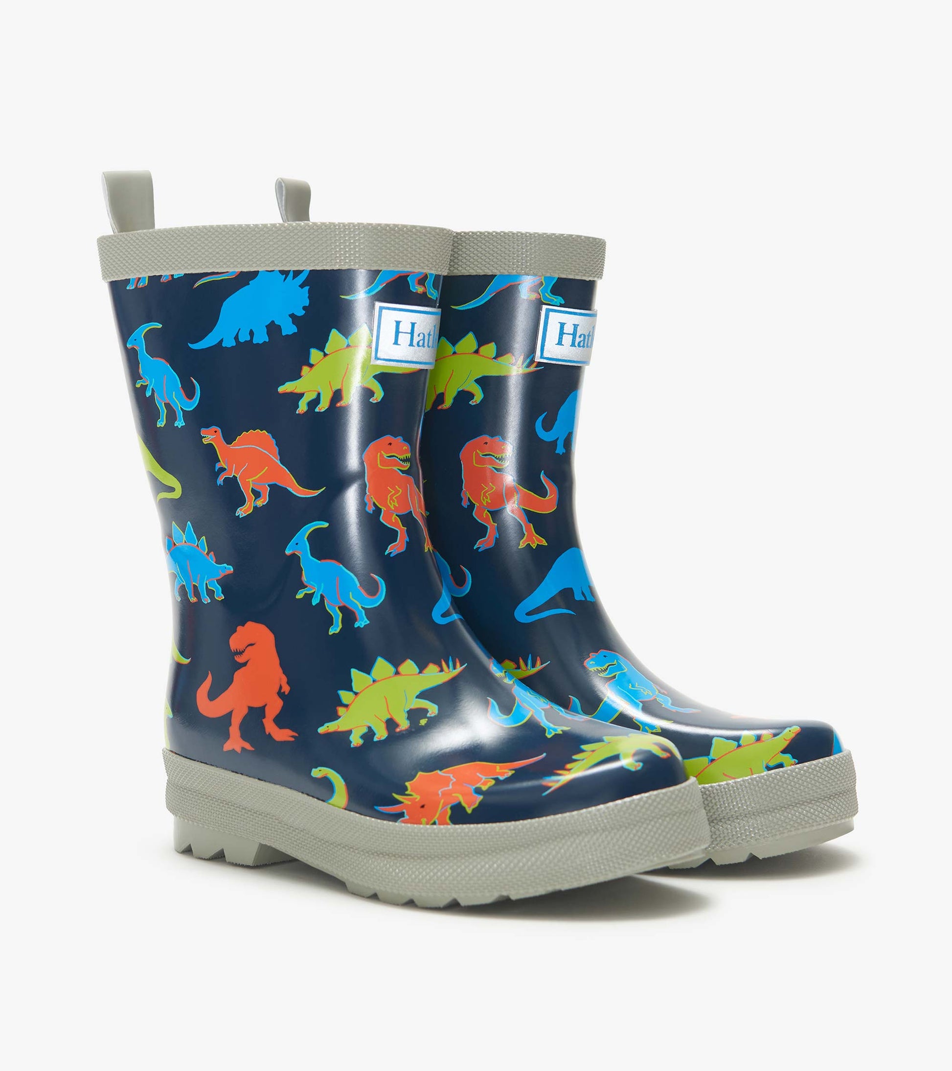 Pair of navy kids rain boots with colorful dinosaur print and gray trim, side view