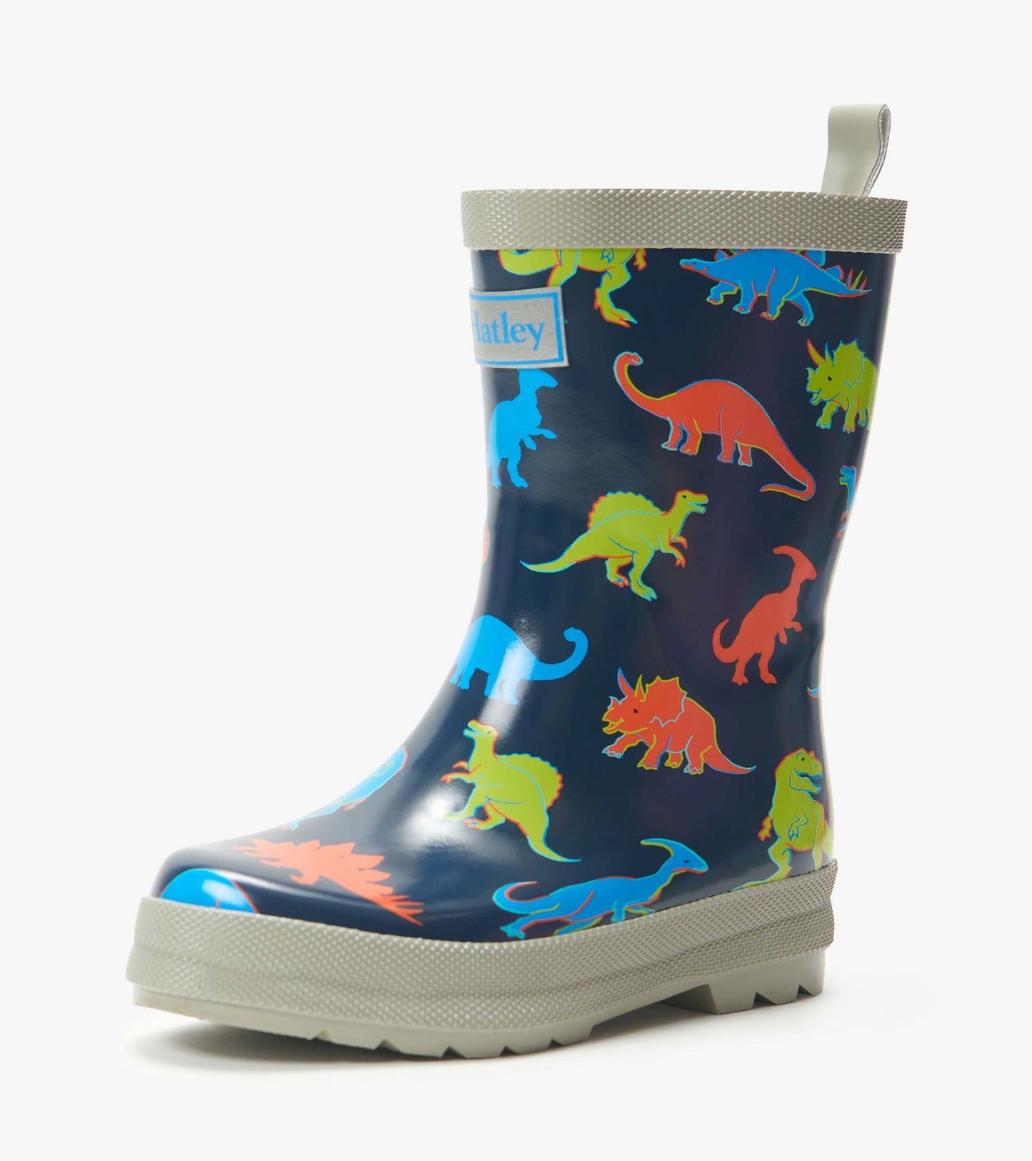 Navy kids rain boot with colorful dinosaur print and light gray trim, side view