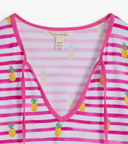 Pink and white striped beach dress featuring pineapple patterns and a V-neckline.