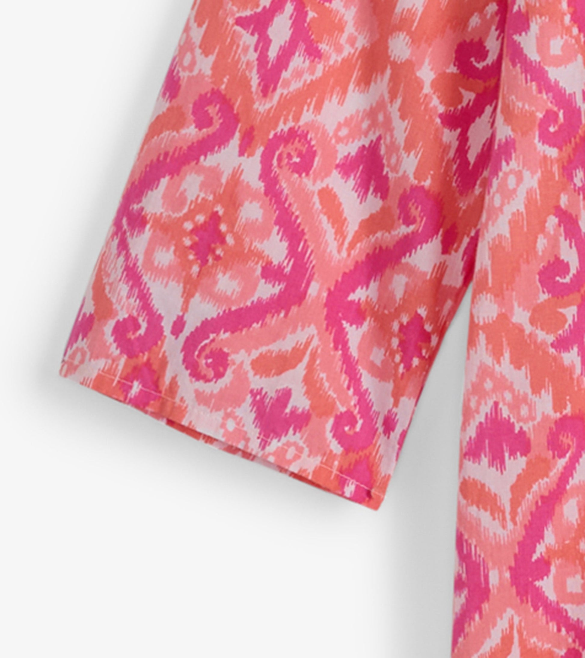 Pink and coral ikat pattern tunic with short sleeves, ideal for casual beachwear.