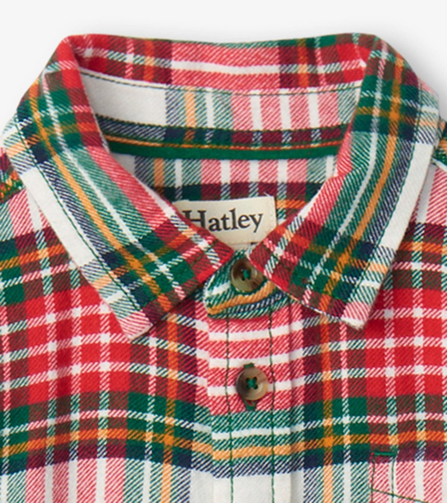 Red, green, and white plaid button-down shirt with a collar and wooden buttons, suitable for festive occasions.