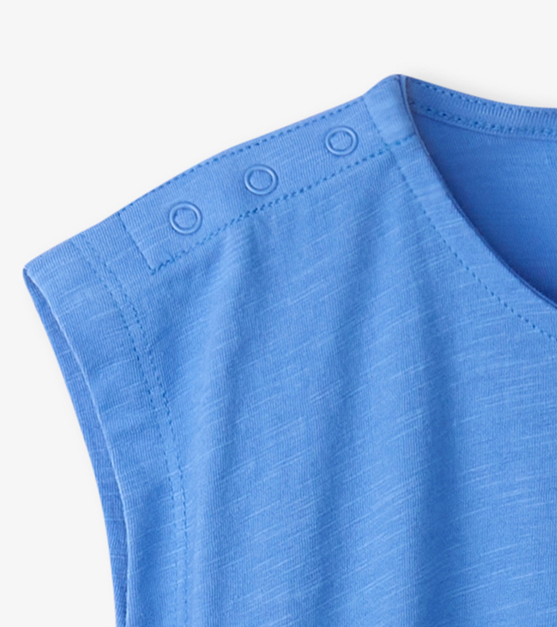 Light blue snap button shirt for baby and toddler girls, featuring a soft fabric and short sleeves.