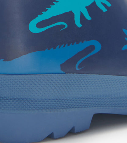 Navy blue kids' wellies featuring turquoise dinosaur silhouettes and a textured sole for grip.