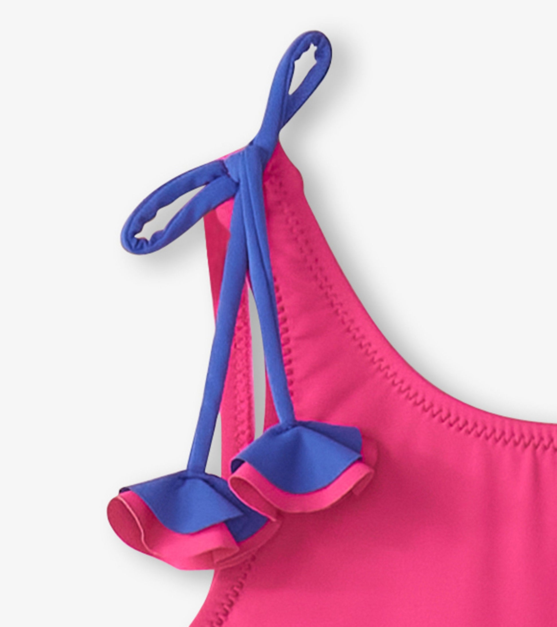 Pink swimsuit with blue shoulder bows and ruffled accents, designed for girls.