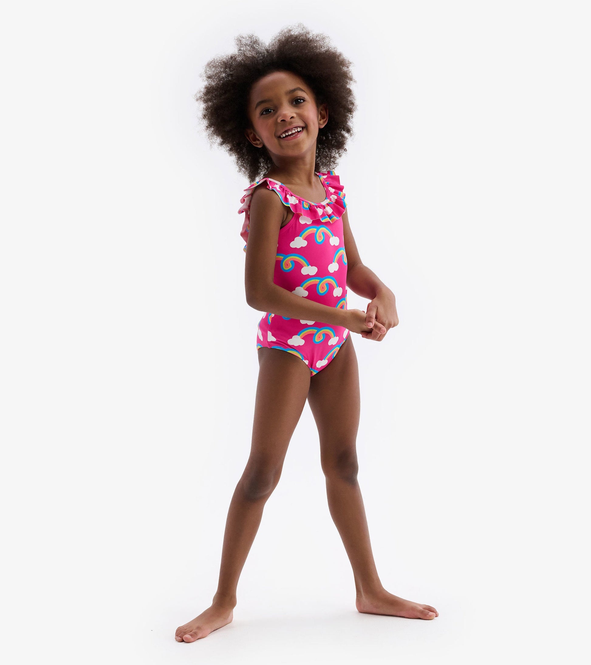 Pink swimsuit with rainbow and cloud pattern, featuring ruffle sleeves, suitable for kids.