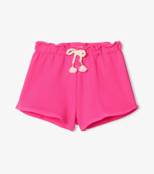 Fuchsia paper bag shorts with a ruffled waistband and drawstring ties, made from soft fabric.