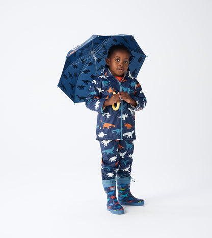 Blue dinosaur-patterned wellies with a Sherpa lining, paired with a matching raincoat and umbrella.