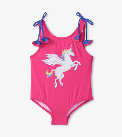 Pink swimsuit featuring a white unicorn graphic and blue shoulder bows. Ideal for summer activities.