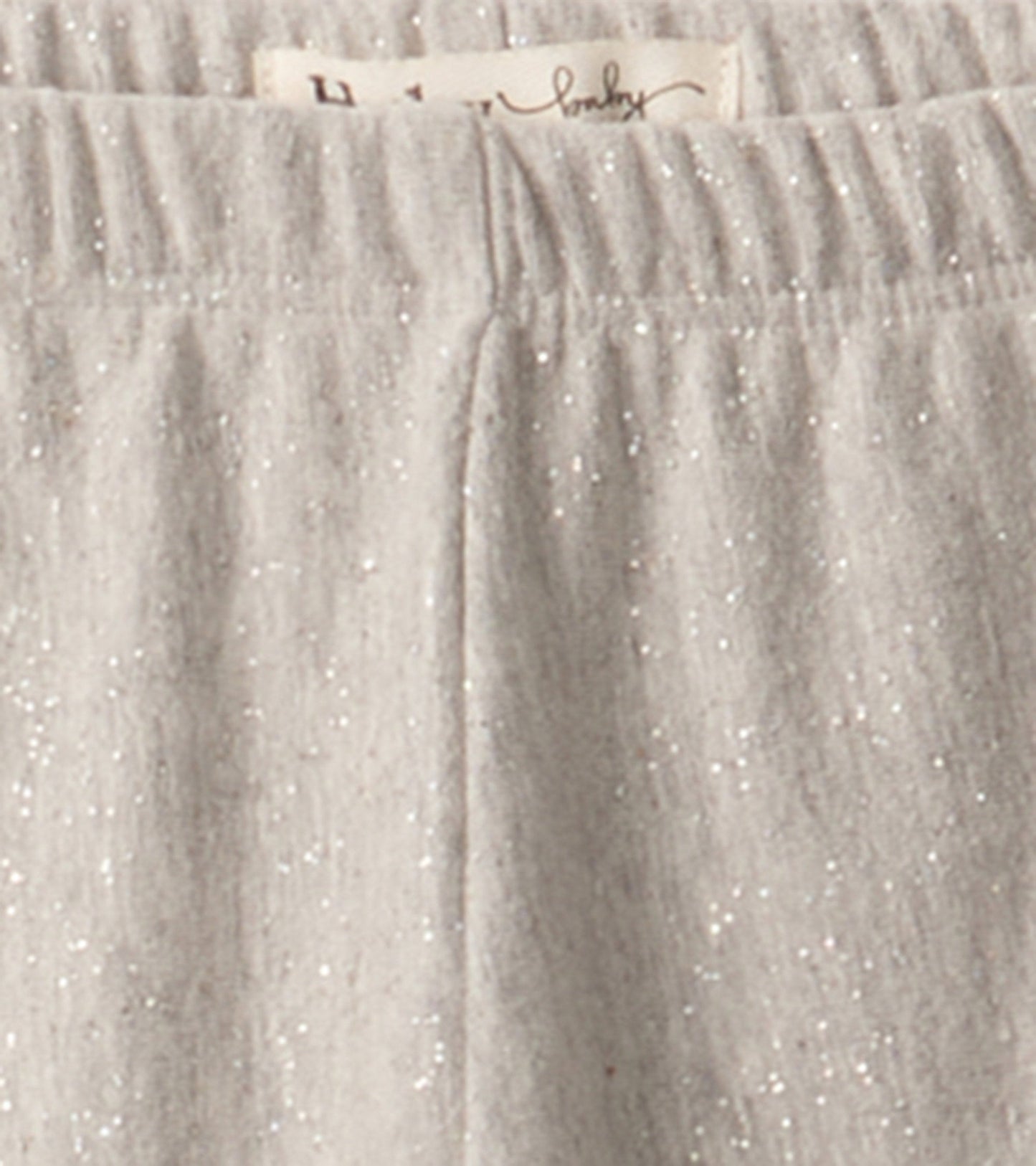 Grey melange leggings with a soft texture and subtle shimmer, featuring an elastic waistband for comfort.