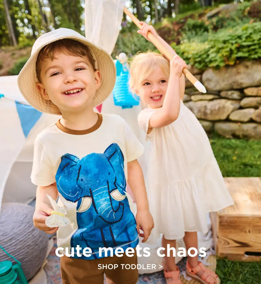 Shop toddler clothing. Showing two toddlers playing outdoors, one wearing a blue elephant graphic t-shirt.